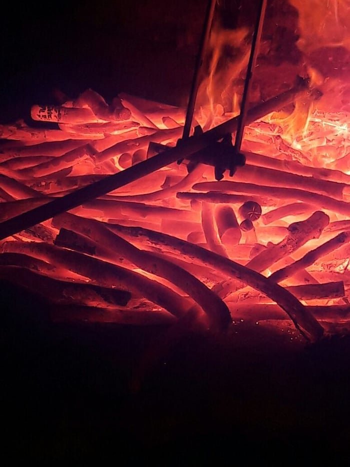 Binchotan glowing red inside a traditional kiln